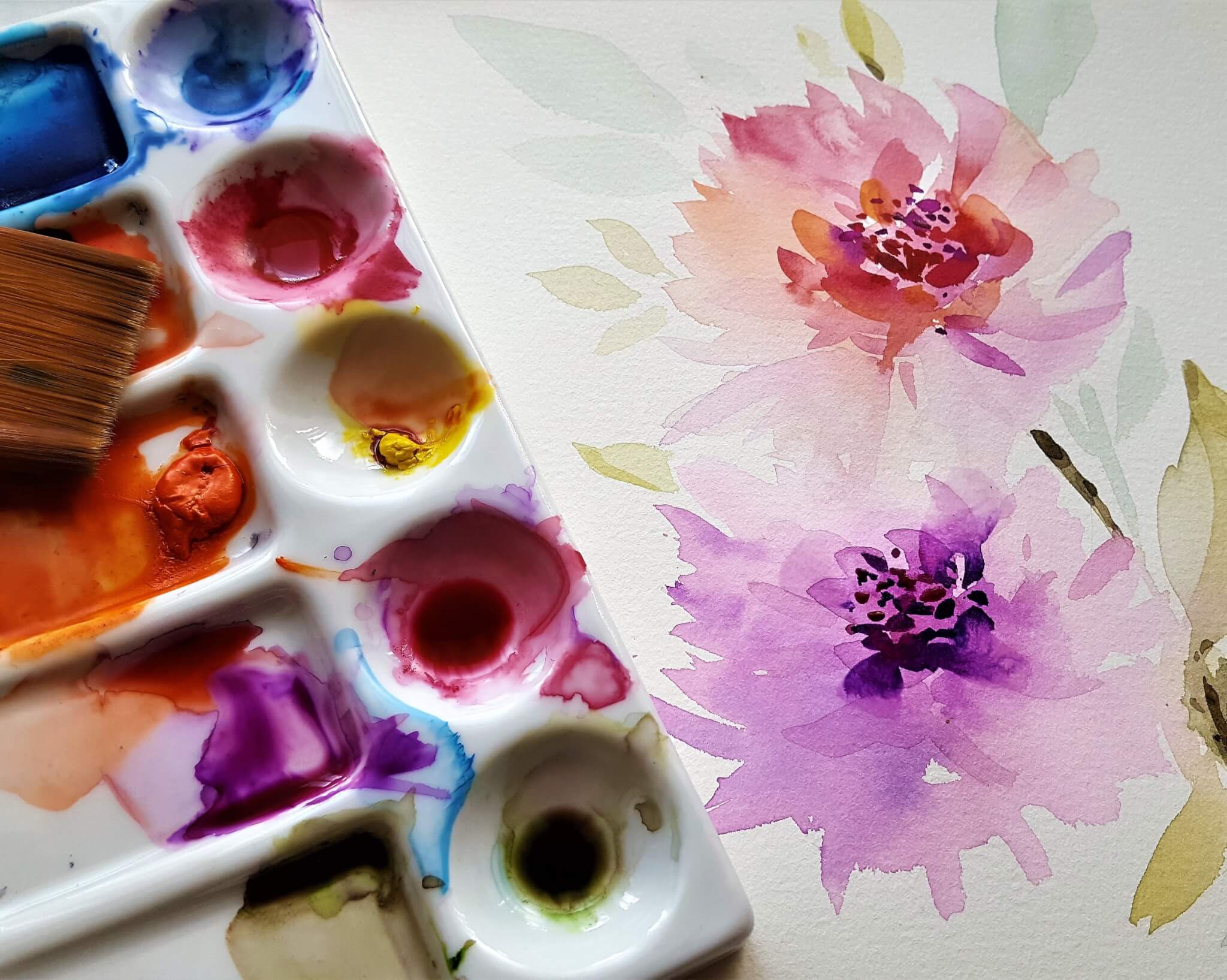 close up image of water colour paints and flowers