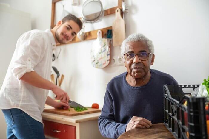 pexels-kampus-7551592 Person preparing food for an elderly male